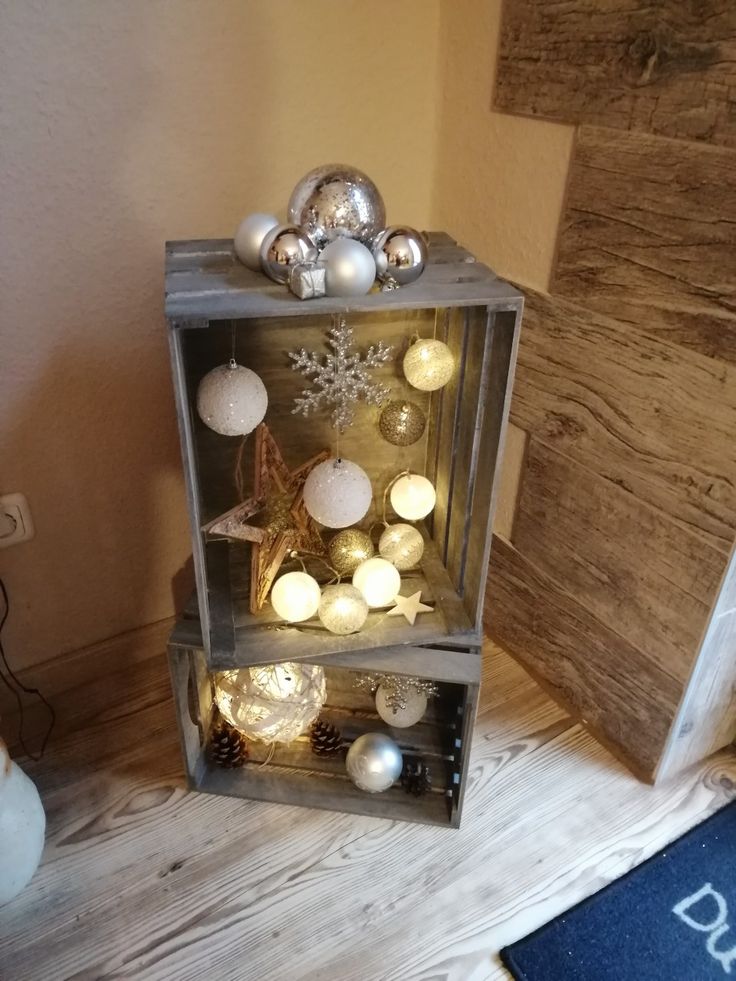 a display case filled with ornaments on top of a wooden floor next to a door