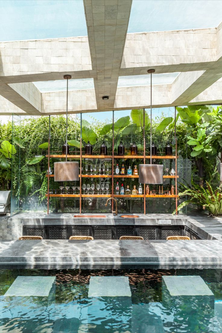 an outdoor bar with lots of bottles on the shelves