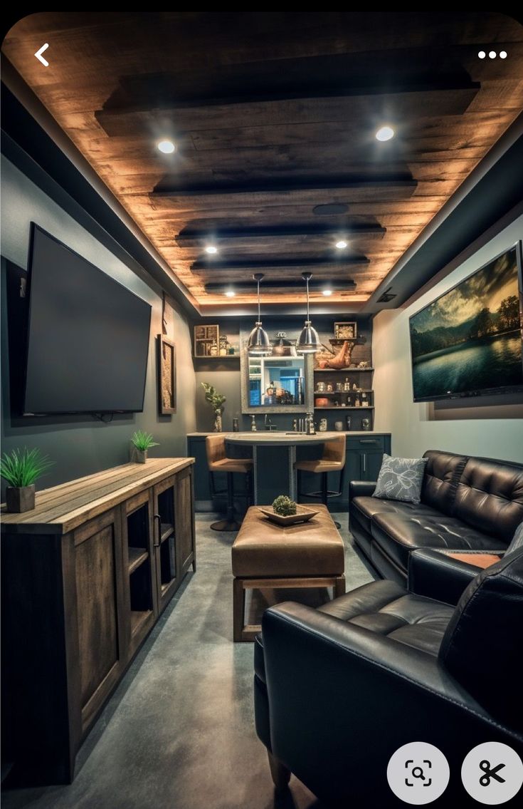 a living room filled with furniture and a flat screen tv mounted to the wall next to a bar