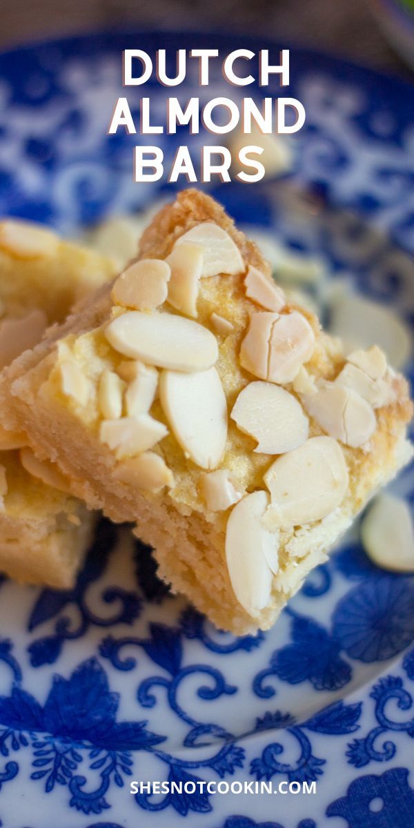 two pieces of almond bars on a blue and white plate with the words dutch almond bars