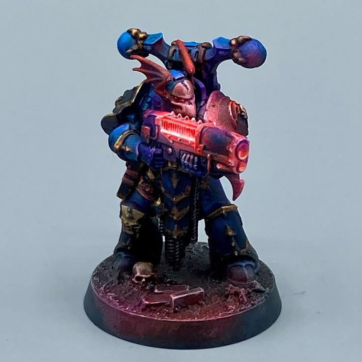 a painted warhammer with a red light on it