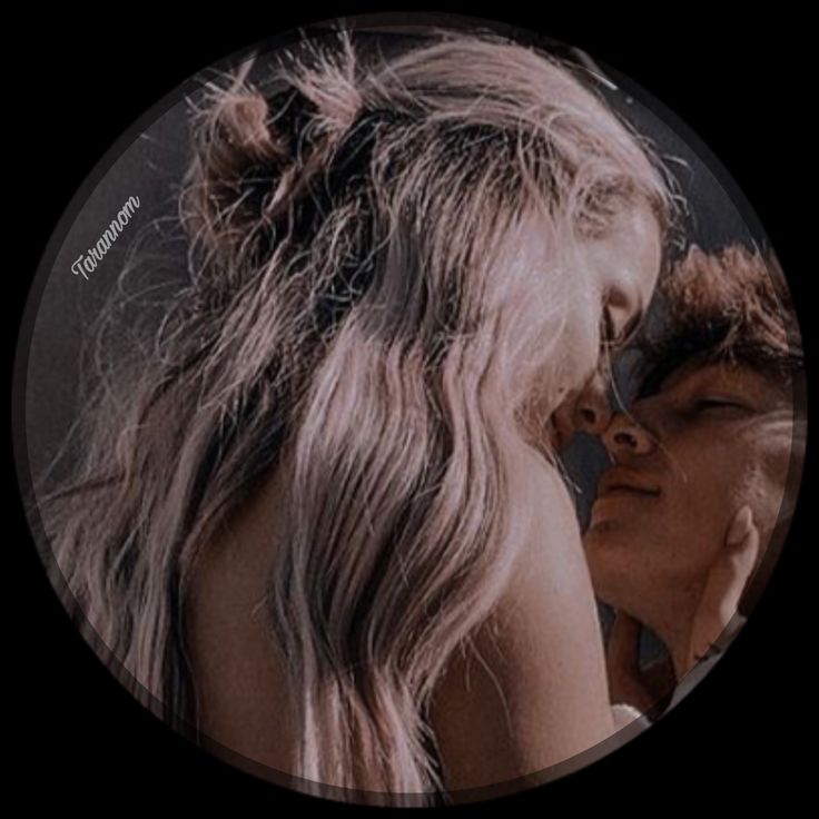 a man and woman kissing in front of a black circle with the words love is all around them