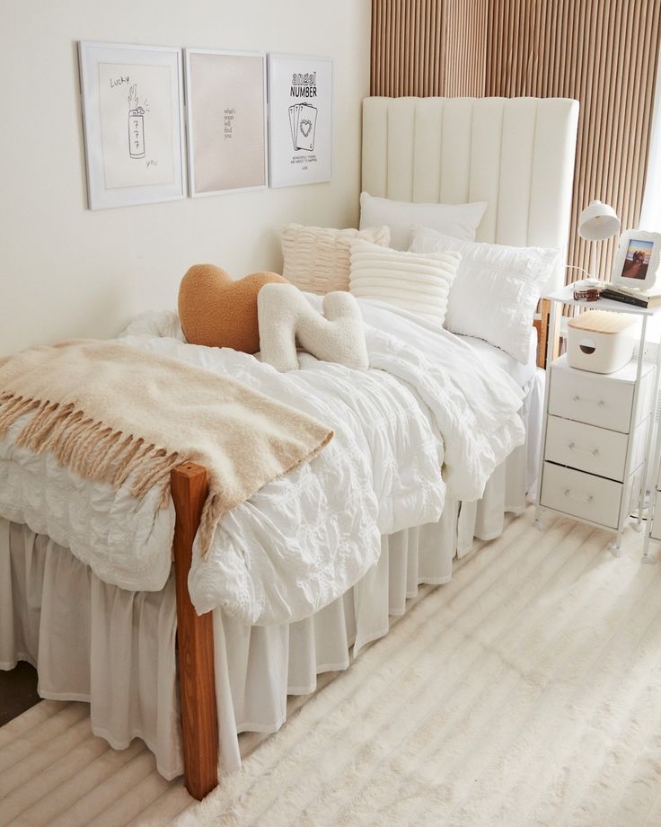 a white bed sitting in a bedroom next to a window