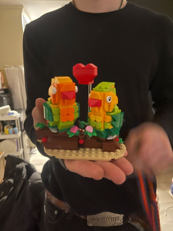 a person holding a lego boat in their hands