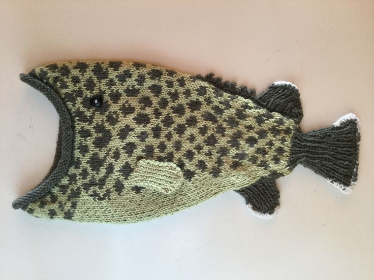 a knitted fish sitting on top of a table