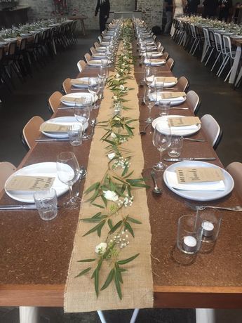 the long table is set with place settings