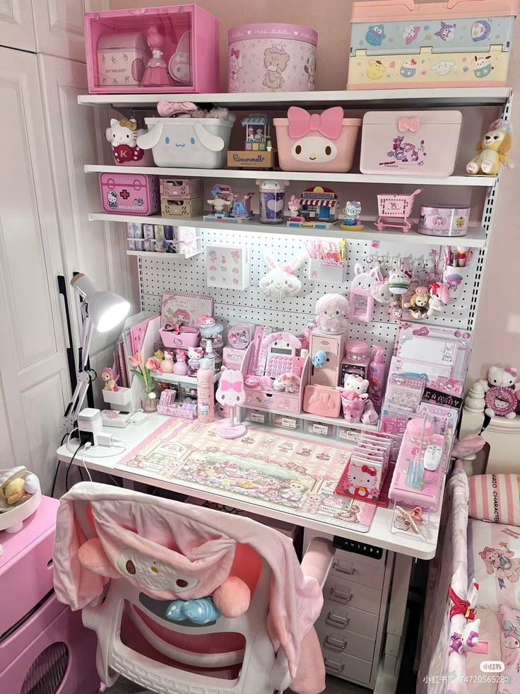 a room filled with lots of toys and decor on top of a white desk next to a pink dresser