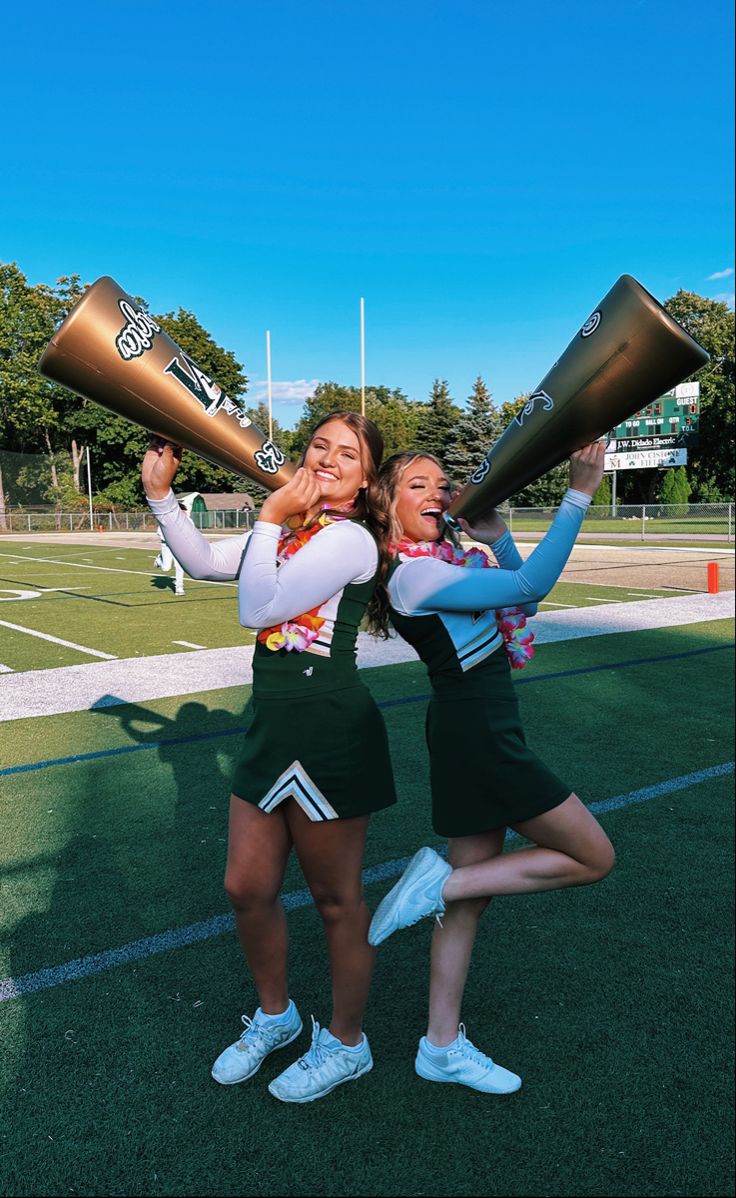 two cheerleaders are holding their trophies and posing for the camera