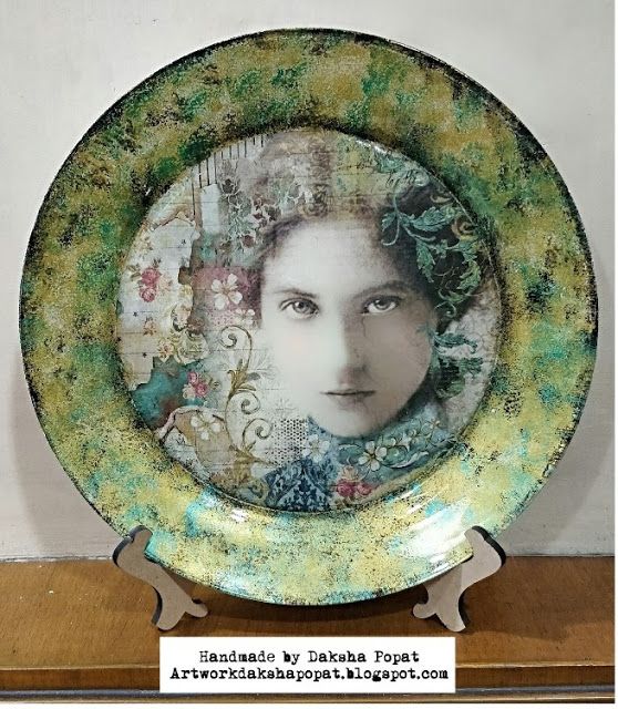 a green plate with a woman's face in the center on a wooden stand