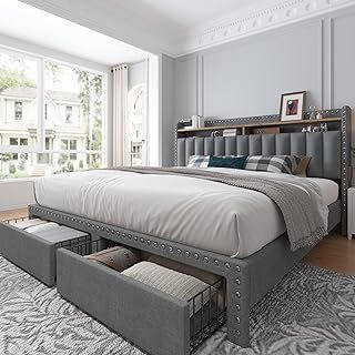 a bedroom with a large bed and storage drawers on the bottom shelf in front of it