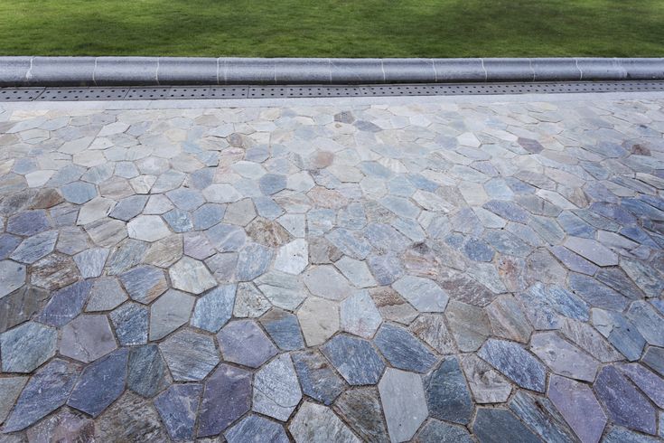 a bench sitting on top of a stone walkway