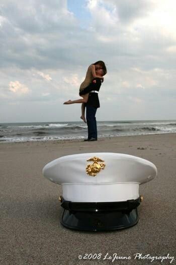 a woman is standing on the back of a lifeguards hat at the beach