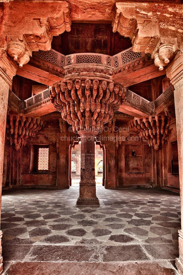 the inside of an old building with stone floors and pillars, decorated in intricate carvings