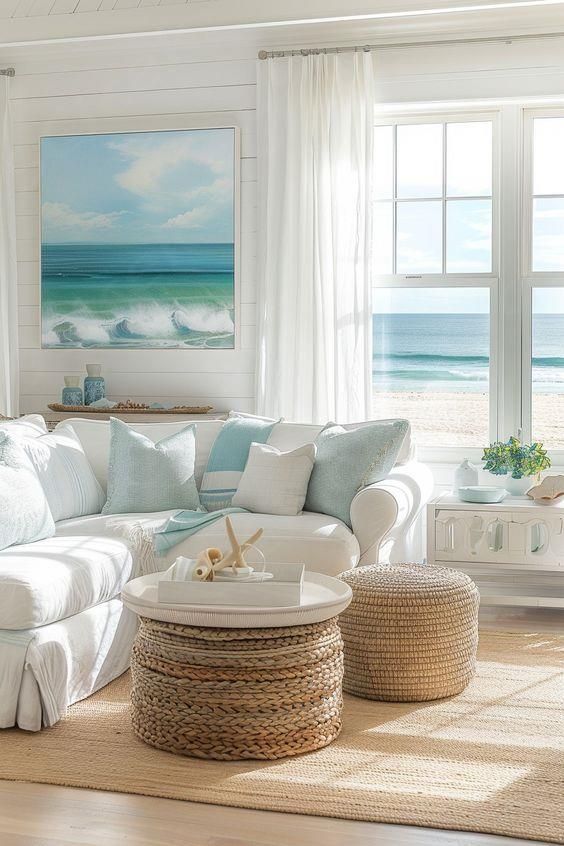 a living room filled with white furniture and lots of windows