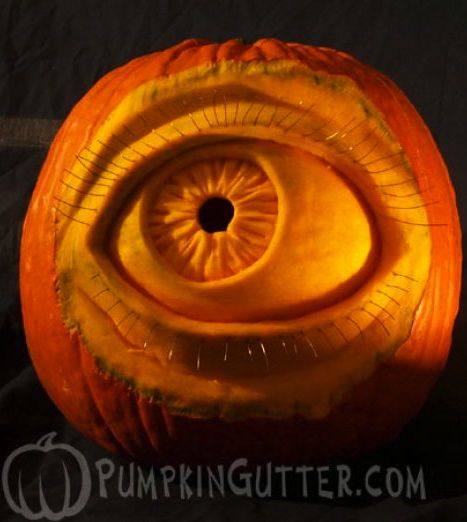 a carved pumpkin with an eye on it