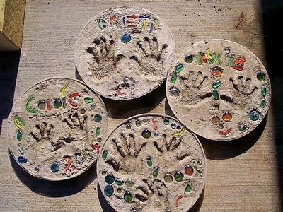 four handprinted plates sitting on top of a table