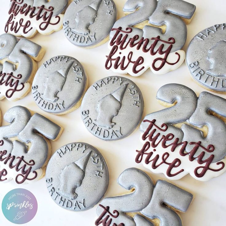 decorated cookies with the words twenty five and twenty five are arranged on a white surface