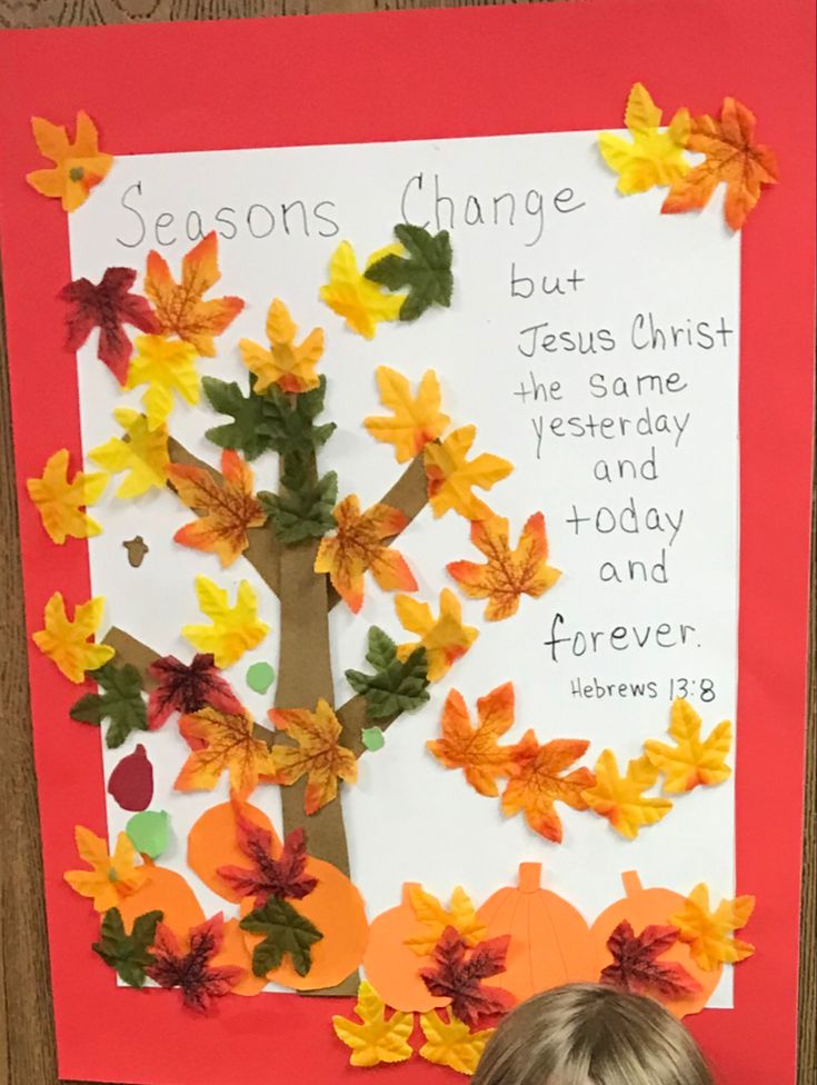 a child is looking at a paper tree with leaves on it and the words seasons change are