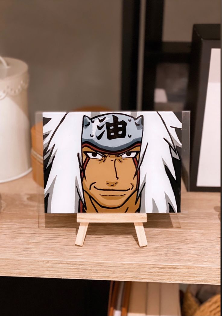 a wooden table with an anime character painted on the front and back of it's face