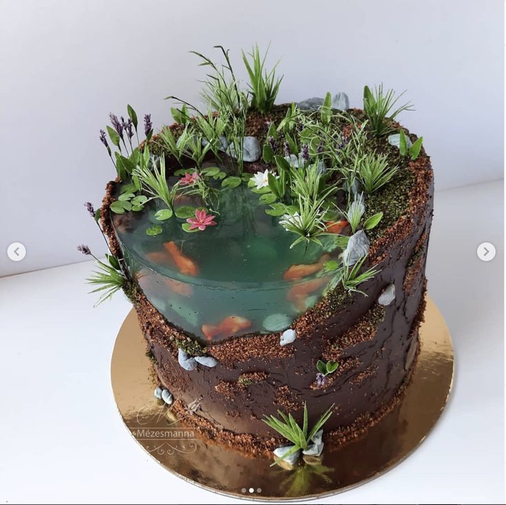 there is a cake with plants and fish in it