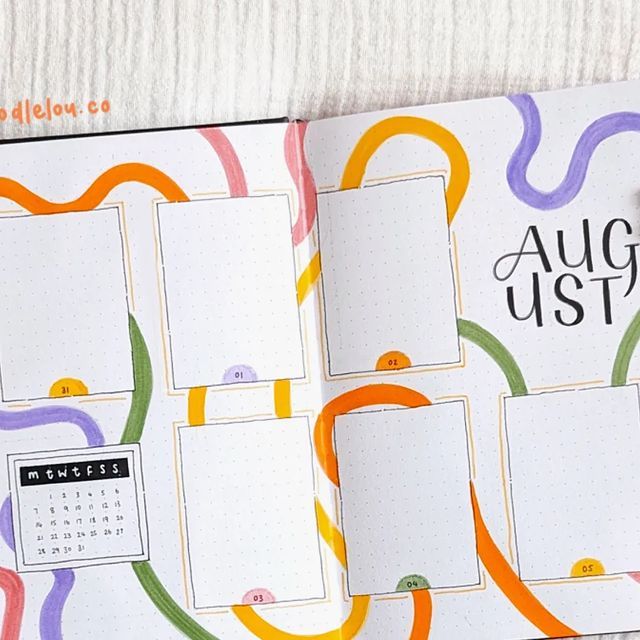 an open planner book with colorful circles and the words august written in black on it