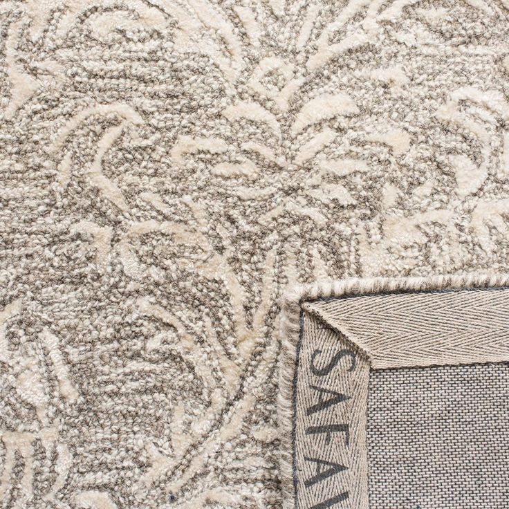 an area rug with the word safa written in white and grey on top of it