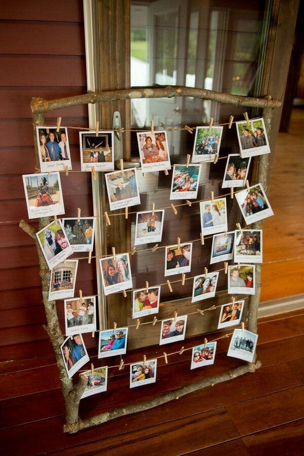 an old window is decorated with photos and clothes pins for family members to hang on