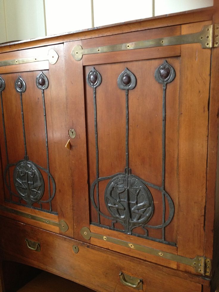 an old wooden cabinet with metal handles and knobs