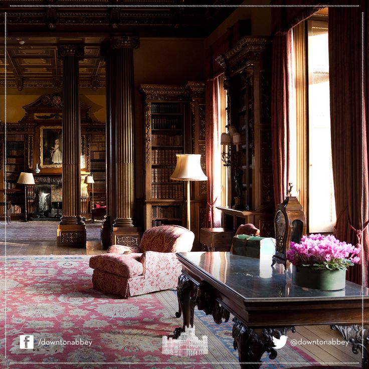 a living room filled with lots of furniture and bookshelves in front of large windows