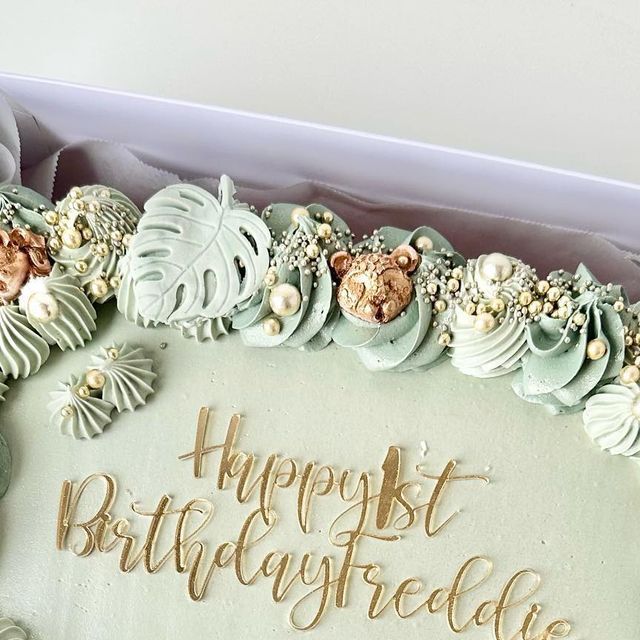 a birthday cake with the words happy 1st birthday spelled in frosting on it's side