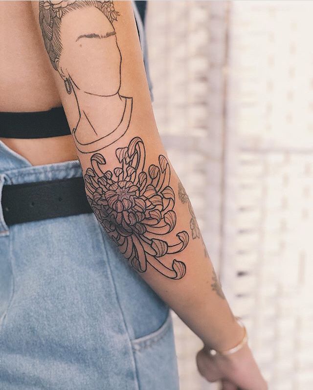 a woman with a tattoo on her arm