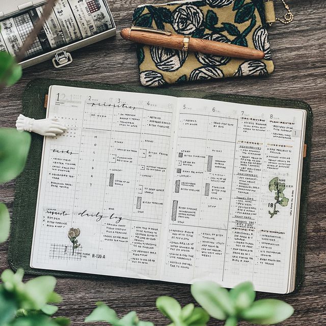 an open planner sitting on top of a wooden table