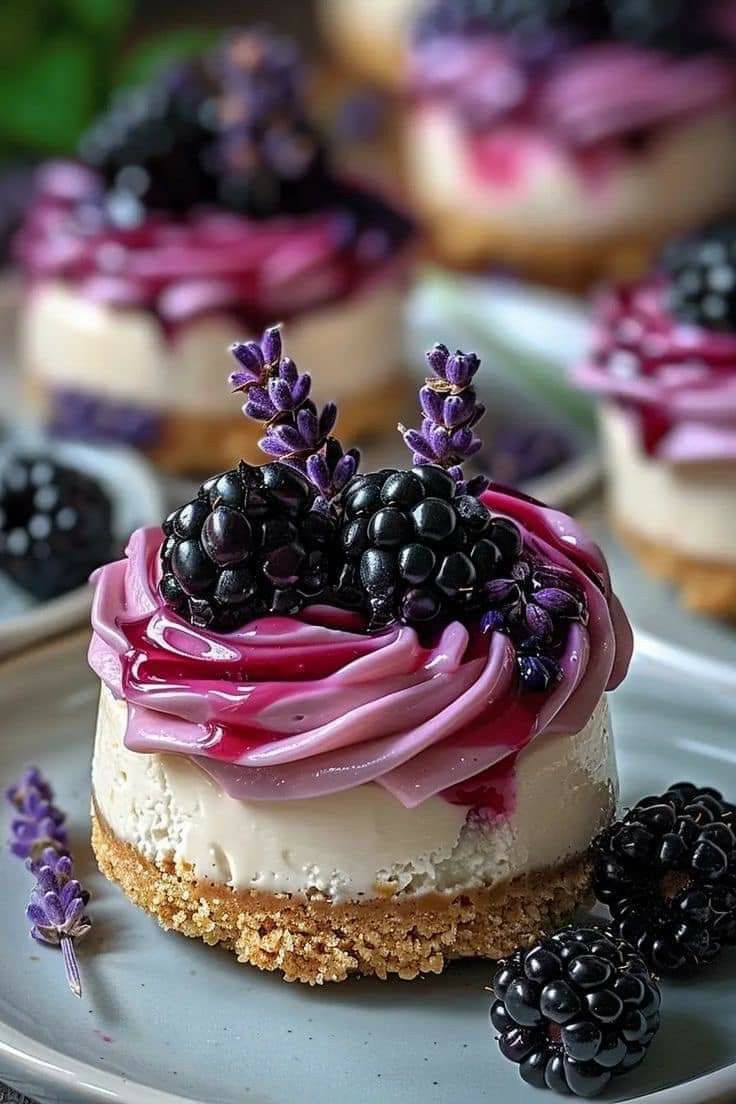 there is a dessert on the plate with blackberries and lavender sprinkles