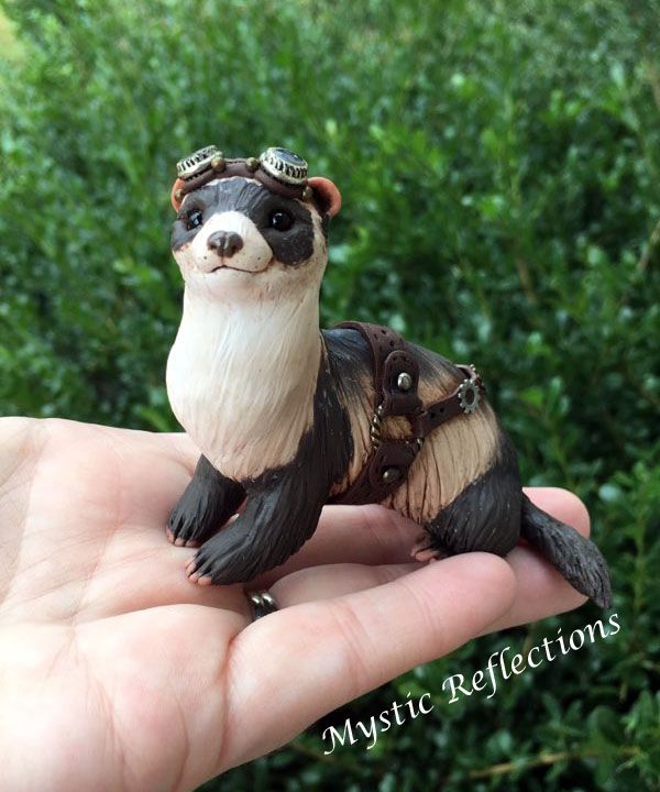 a hand holding a small toy animal in it's palm