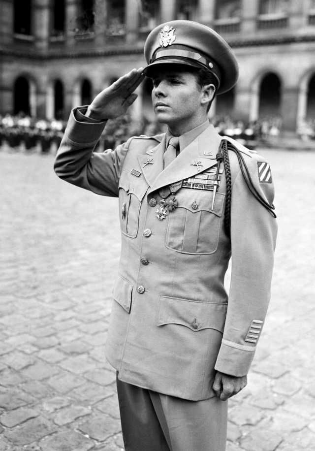 a black and white photo of a man in uniform