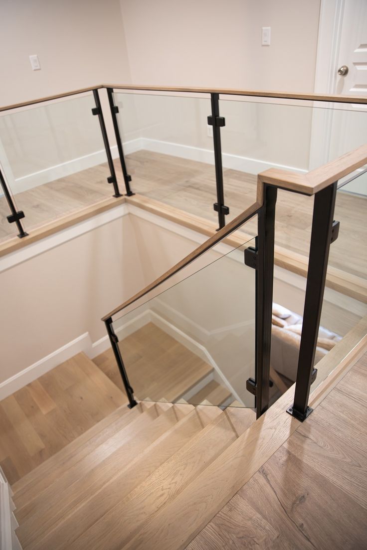 Stair, modern, home, glass railings, metal, posts, glass panels, staircase, design, style, farmhouse, Glass Stairways Modern, Modern Stairs With Glass Railing, Metal And Glass Staircase, Interior Glass Railing Ideas, Black Metal Interior Stair Railing, Stairway Hallway Decor, Glass Loft Railing, Black And Glass Staircase, Indoor Glass Railings