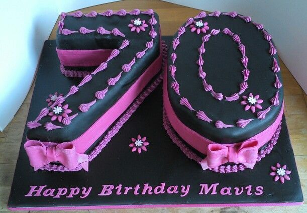 a black and pink birthday cake with flowers on it