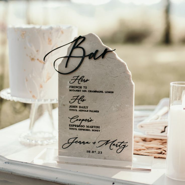 a table set up for a wedding reception with a cake and candles on it,