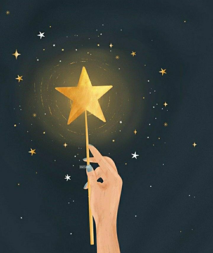 a hand holding a gold star in the night sky