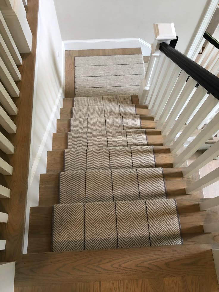 the stairs are made of wood and have beige carpet