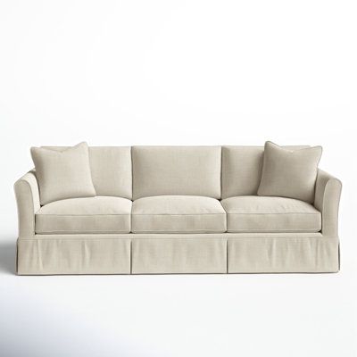 a white couch with four pillows on it