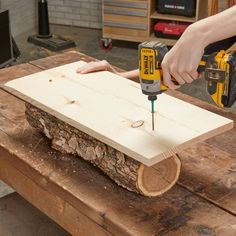 a person using a drill to cut wood