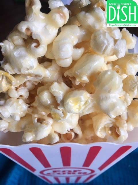 a bowl filled with popcorn sitting on top of a table