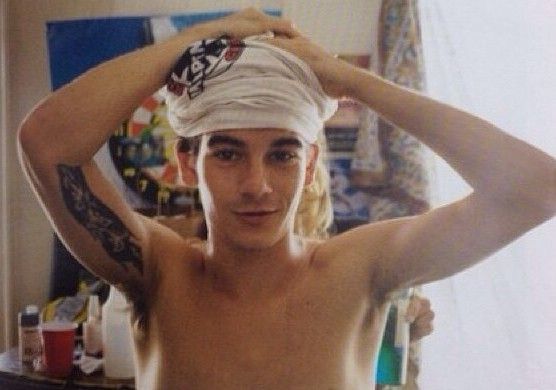 a shirtless man with a towel on his head