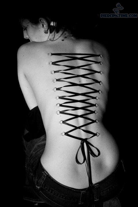 the back of a woman's body with scissors on it