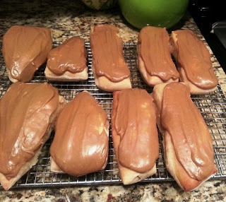 chocolate frosted donuts cooling on a wire rack