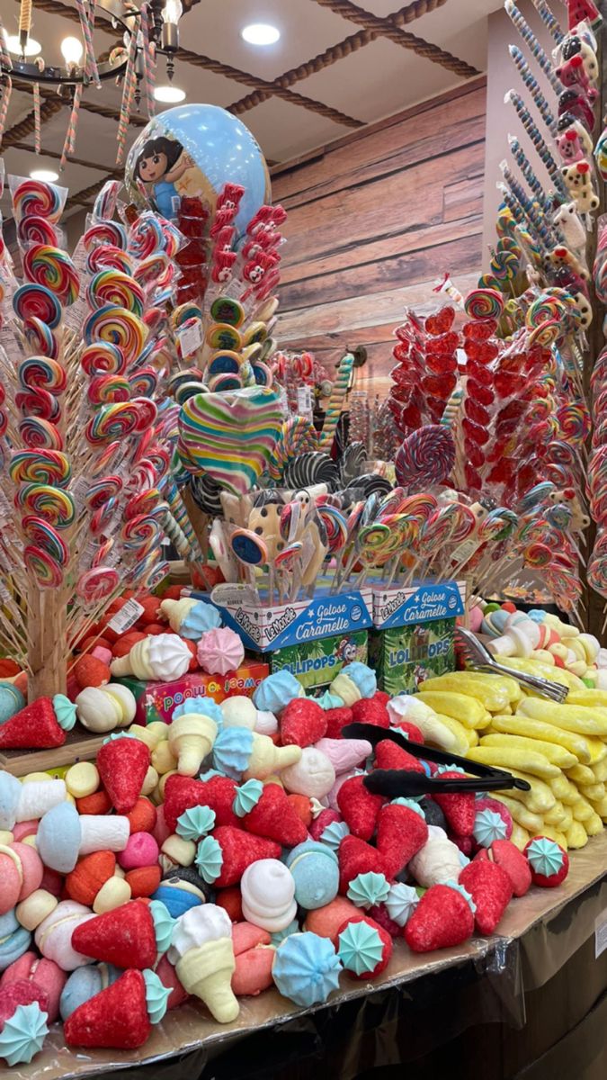 a table topped with lots of candy and lollipops