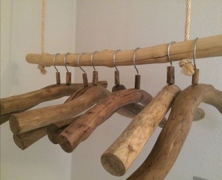 a wind chime made out of driftwood and wood sticks hanging from the ceiling