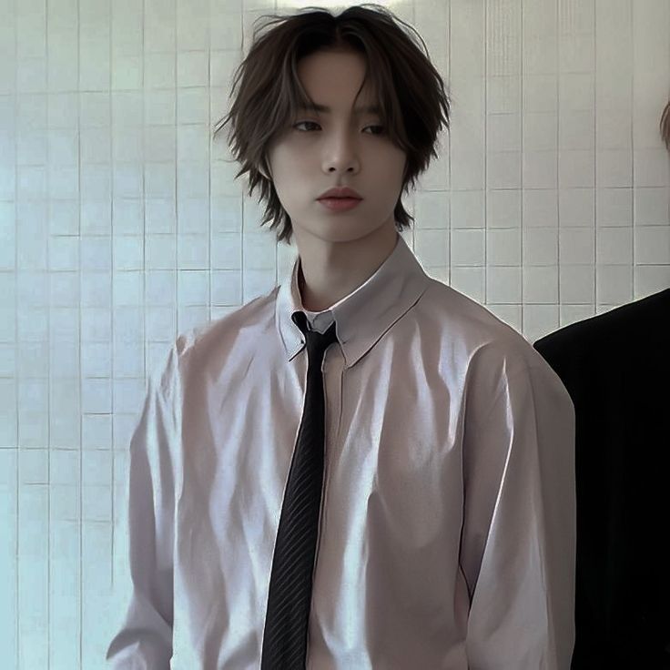 two young men standing next to each other in front of a white tiled wall and floor