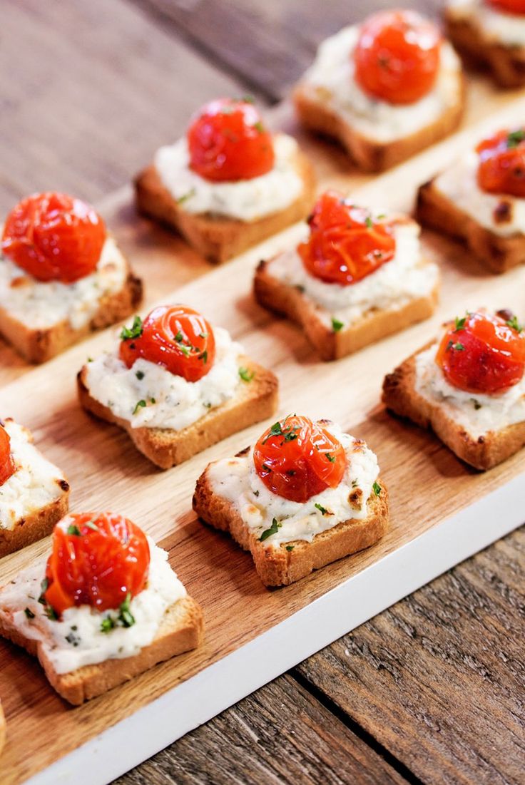 small pieces of bread topped with tomatoes and cream cheese